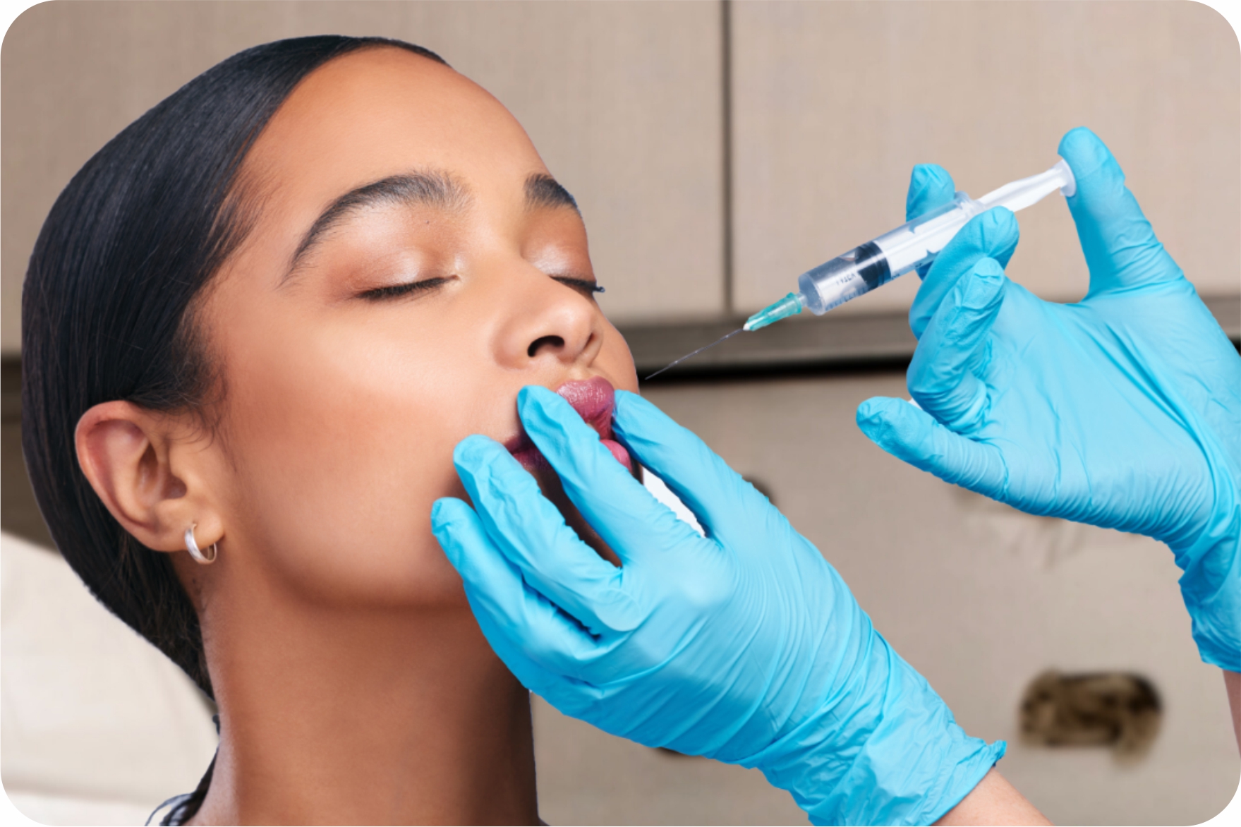 Close-up of a woman gently touching her glowing skin, representing skincare treatments from B.E. The Skin.